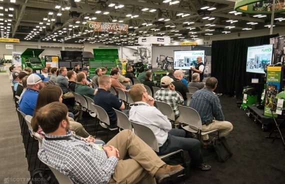 a seated crowd watches a demonstration at a breakout class in the expo hall at the Austin Convention Center during the John Deere expo.