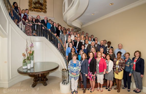 a large group portrait on the stairs at the Hilton San Antonio
