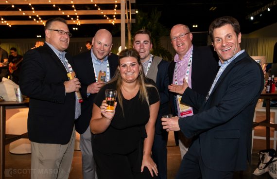 a group of people smiling at the camera at a distributors conference