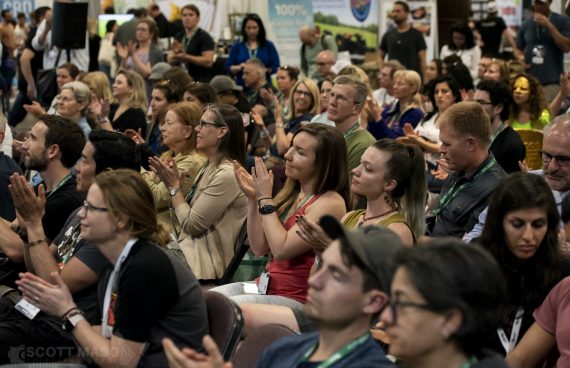 audience members applauding at a conference
