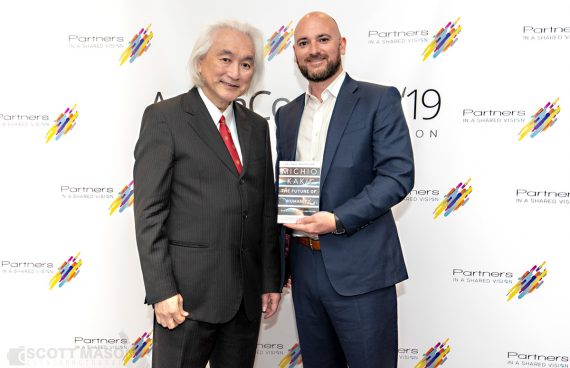 Michio Kaku and a conference attendee at a Meet n Greet