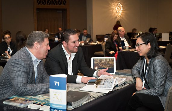 three hotel industry execs chat at a speed networking event