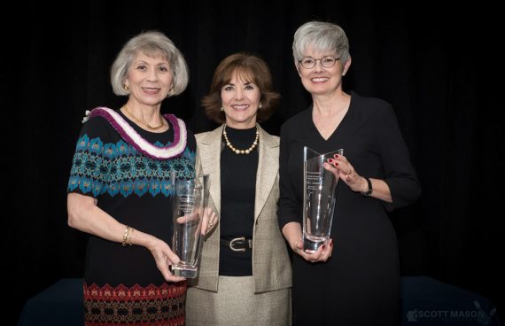 a photo of three women holding an award at an awards ceremony