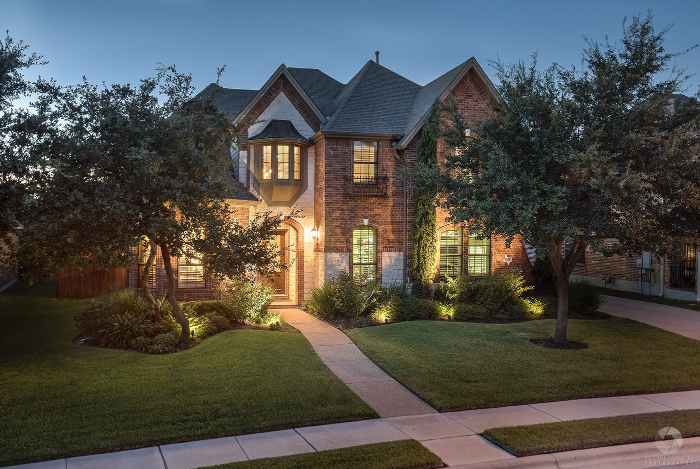 a photo of the front exterior of a home at twilight, elevated at 13 feet up