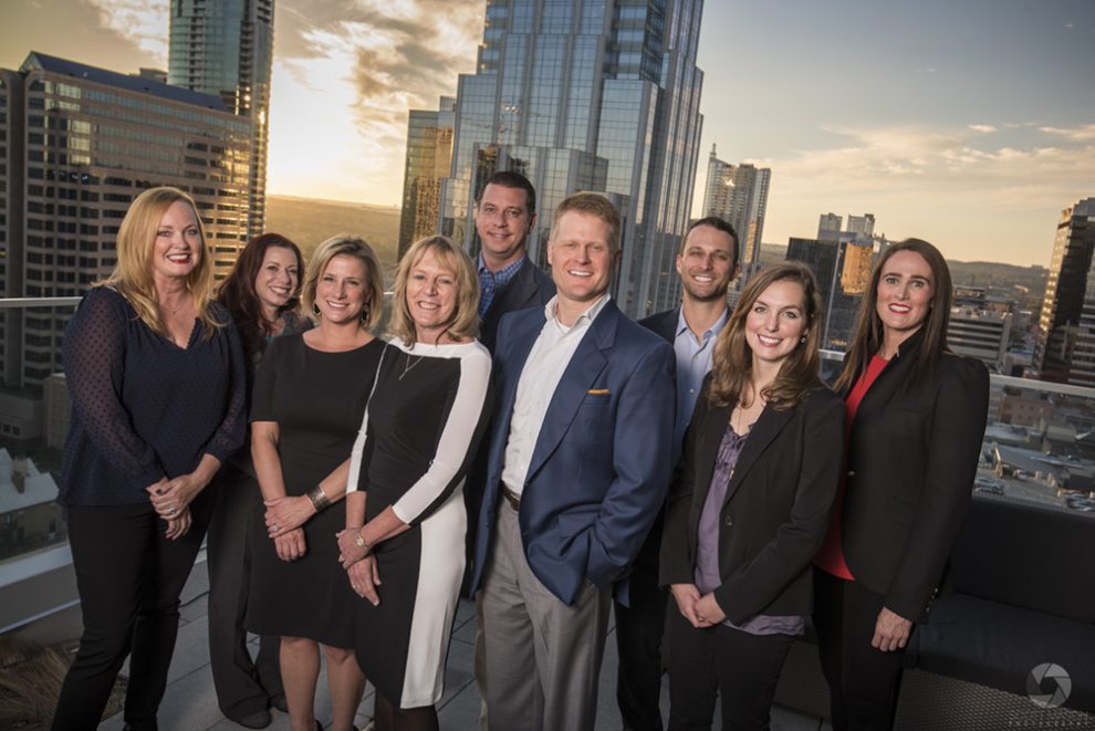 a group business portrait of a company on the roof of the Westin in Austin tx at sunset