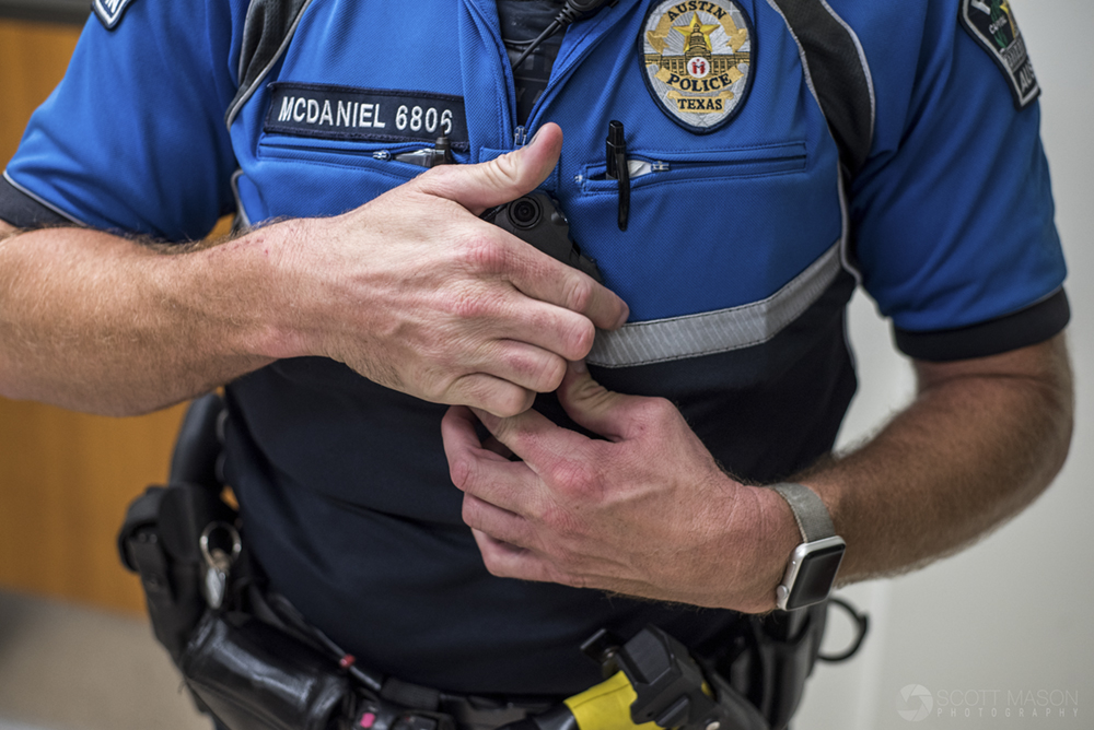 an APD officer putting on his body cam