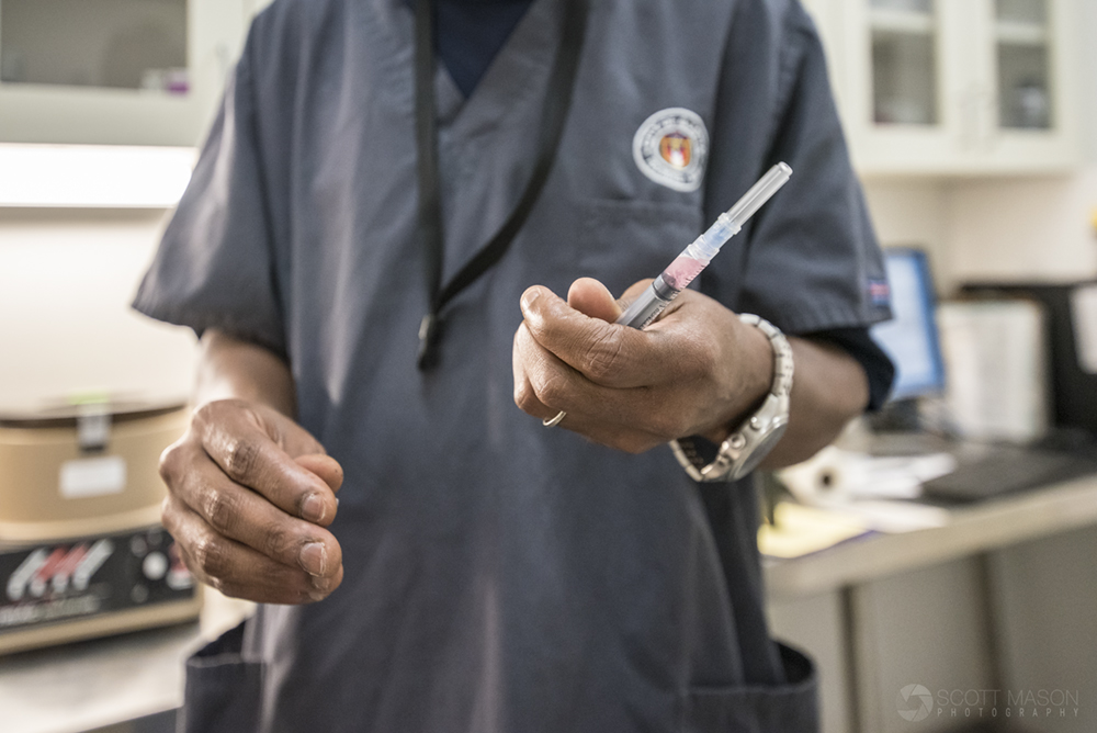 a city-owned rescue worker holding a syringe with a vaccine in it