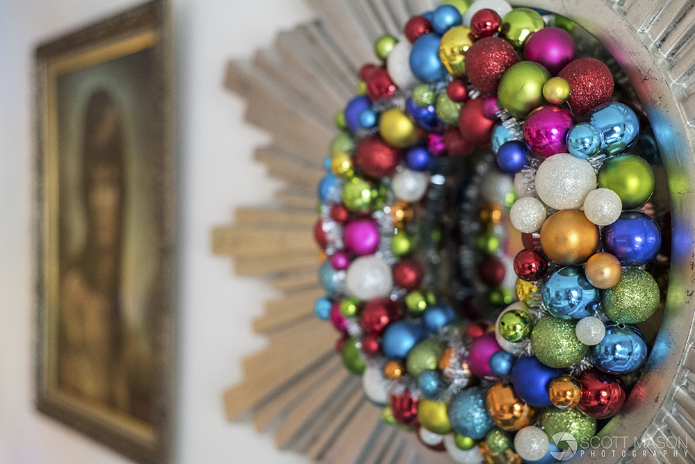 a close-up of a mirror decorated with a christmas ornaments wreath