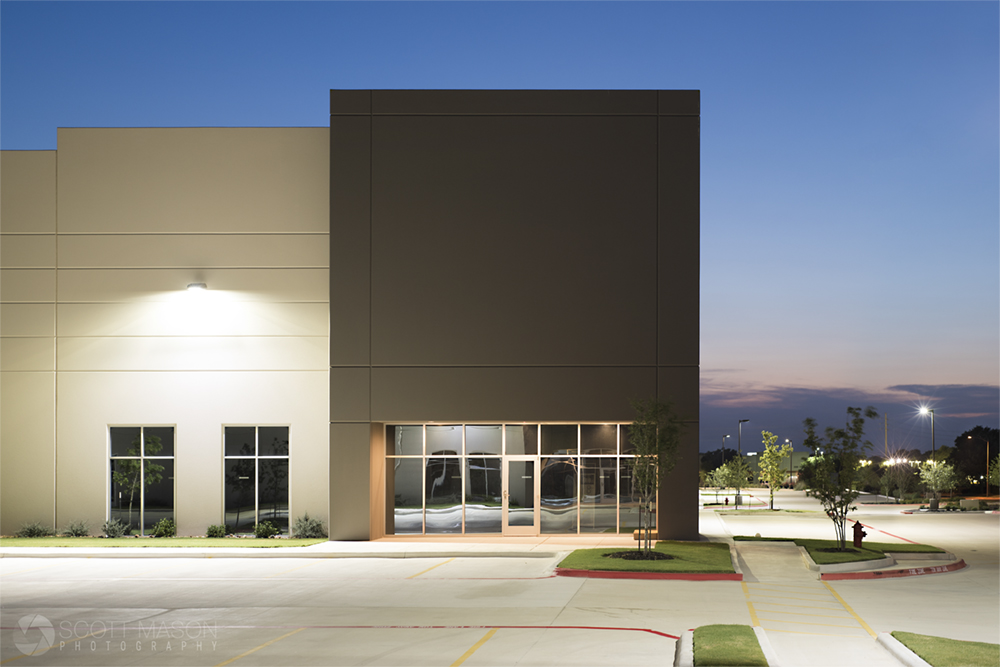 a side view of an industrial commercial building at twilight