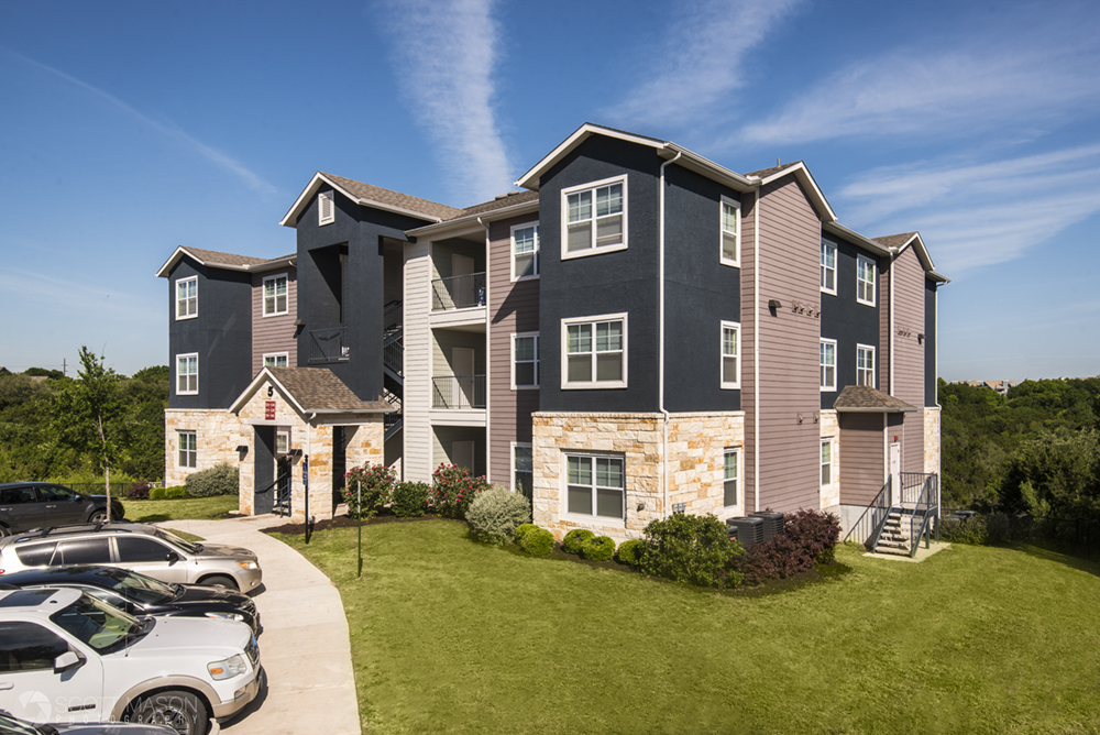 A daytime photo of an apartment complex building