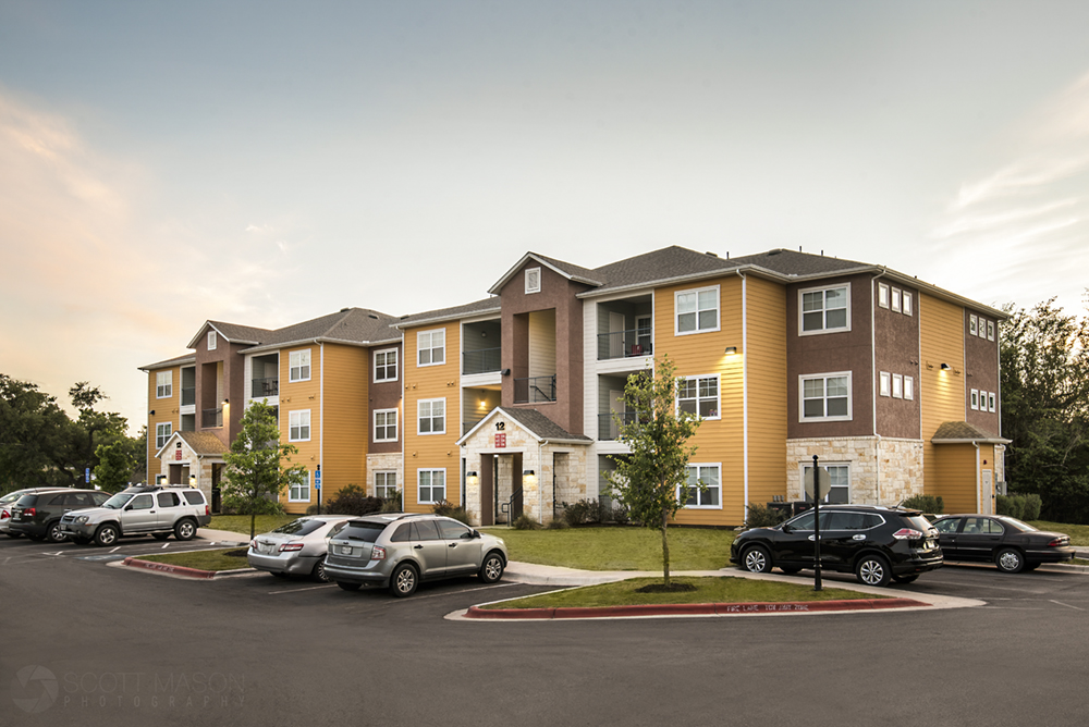 a photo at sunset showing an apartment complex building in Austin