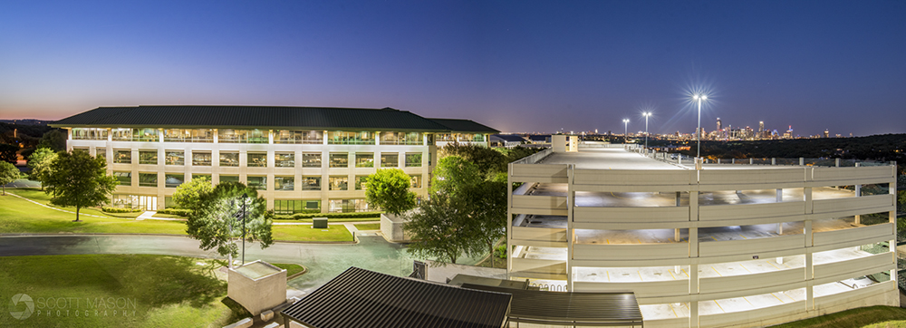 a panorama view of a commercial office building at twilight