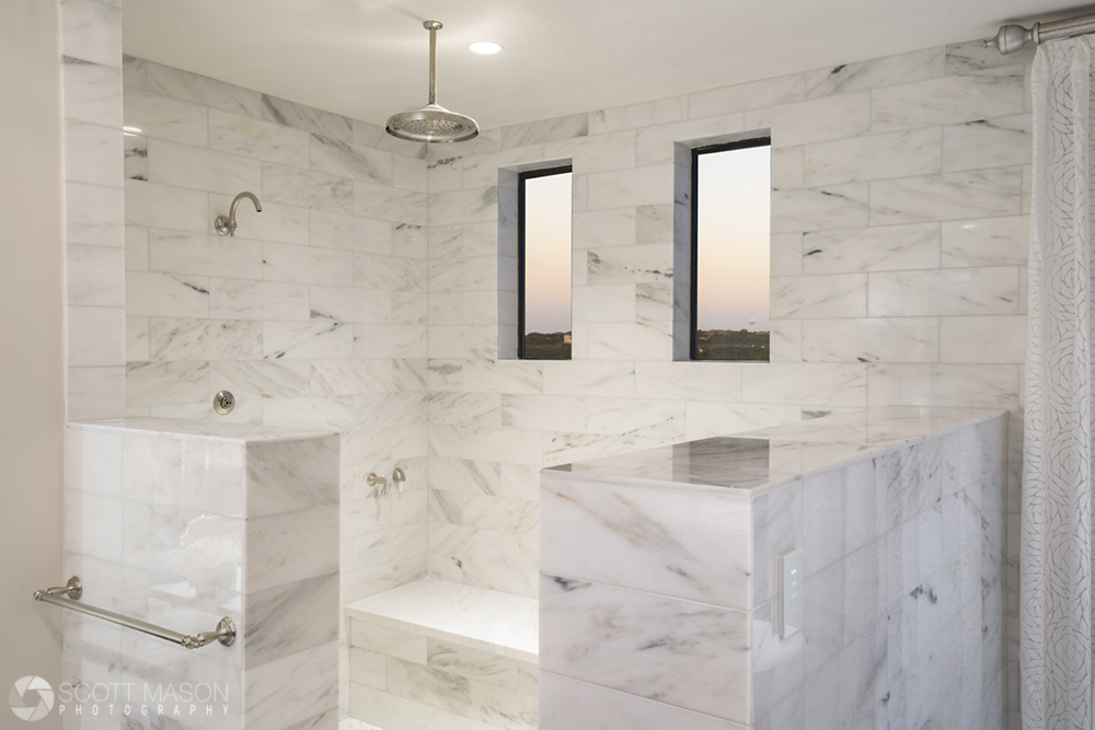 A high-end luxury shower made of white stone tile with windows