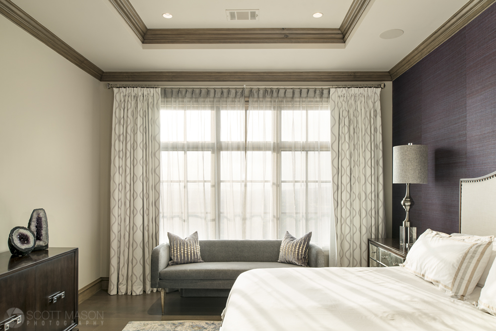 an interior photo of a guest room with a purple accent wall