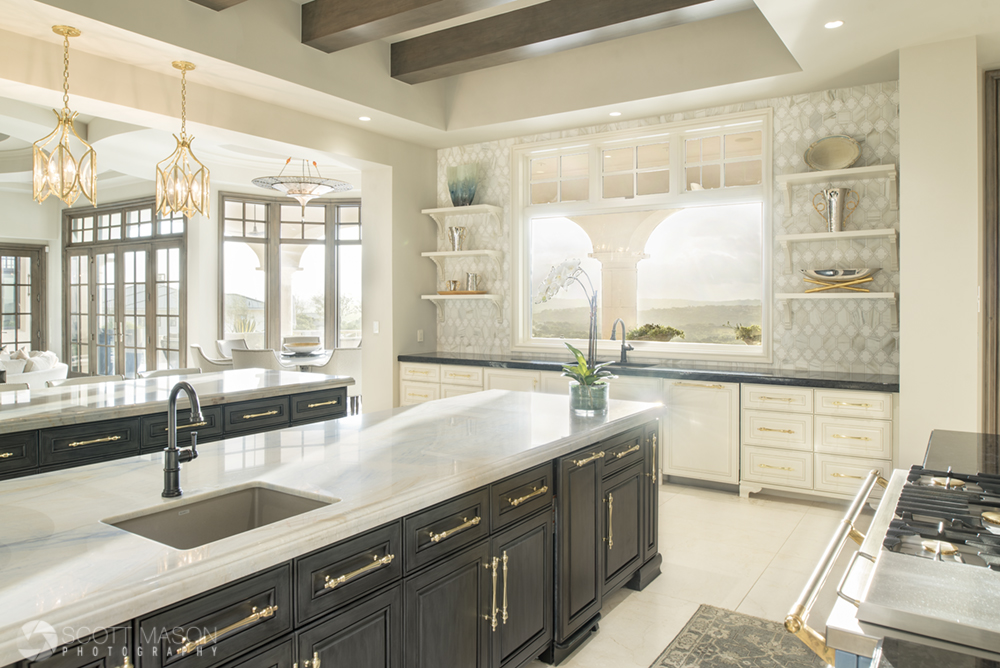 a wide angle interior photo of a luxury kitchen with light coming through the windows