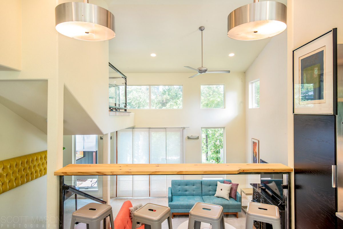 a kitchen interior, looking out over a living room