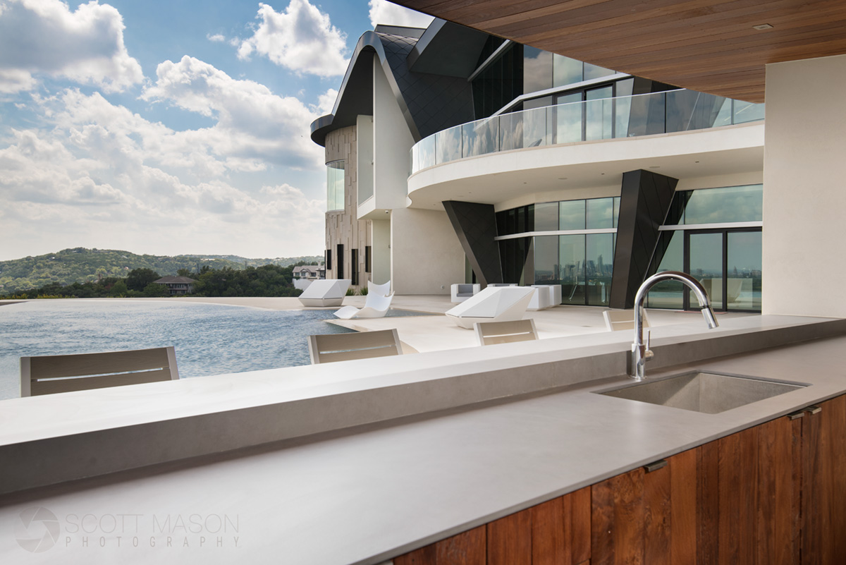 rear exterior photo of a luxury mansion in Austin with a bar and pool