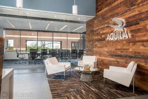 the lobby of Aquila Commercial's office with the conference room behind