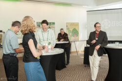 Attendees laughing at a corporate event in Austin, TX