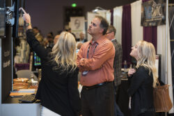 a photo of people in a convention looking at a display